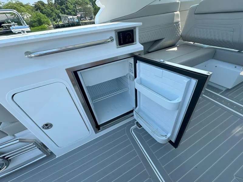 Slide: The Image of 2025 Cruisers Yachts 34 GLS Outboard with open mini fridge on deck. - 22