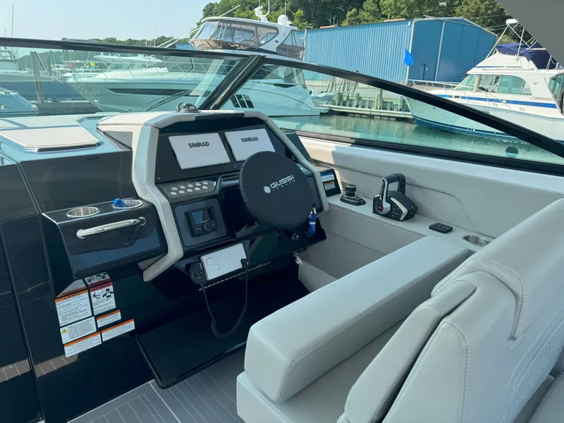 Slide: The Image of 2025 Cruisers Yachts 34 GLS Outboard helm with modern controls and navigation displays. - 27