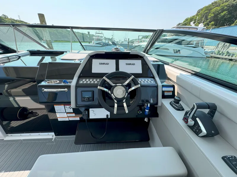 Slide: The Image of 2025 Cruisers Yachts 34 GLS Outboard helm with modern controls and dual Simrad displays. - 28