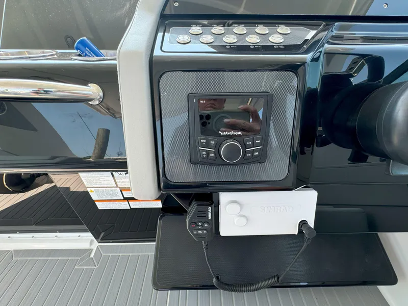 Slide: The Image of 2025 Cruisers Yachts 34 GLS Outboard dashboard with control panel and audio system. - 30