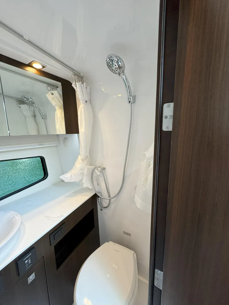 Slide: The Image of 2025 Cruisers Yachts 34 GLS Outboard bathroom with shower, sink, and toilet. - 47
