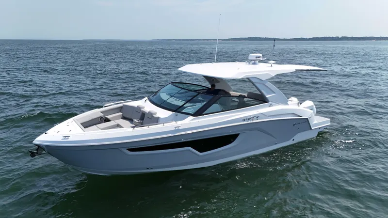 Slide: The Image of 2025 Cruisers Yachts 34 GLS Outboard on open water, sleek design, luxury boating. - 7