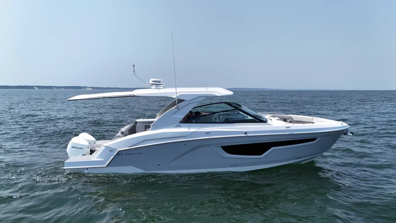 Slide: The Image of 2025 Cruisers Yachts 34 GLS Outboard on open water, side view. - 1