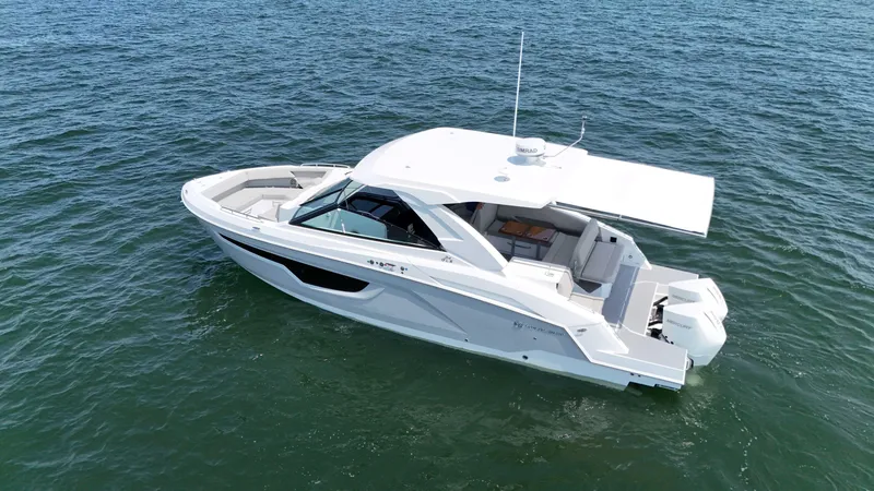 Slide: The Image of 2025 Cruisers Yachts 34 GLS Outboard on open water, sleek design, luxury features. - 11