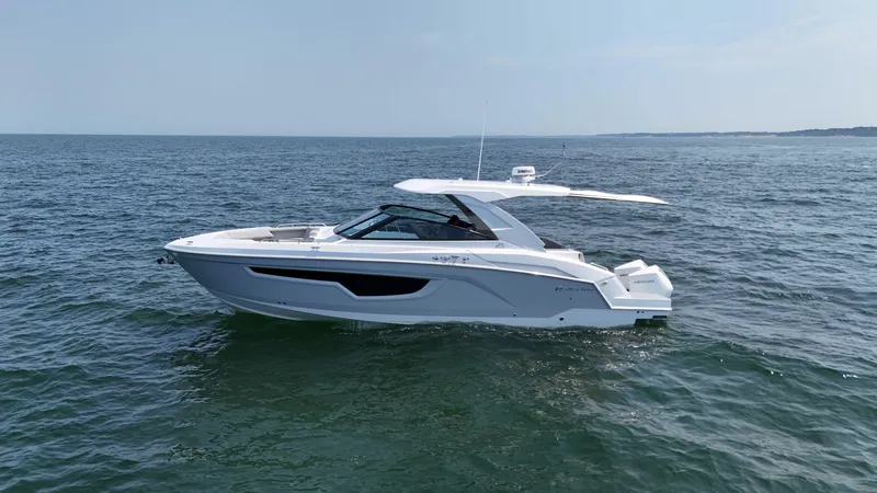 Slide: The Image of 2025 Cruisers Yachts 34 GLS Outboard on open water, sleek design, sunny day. - 12