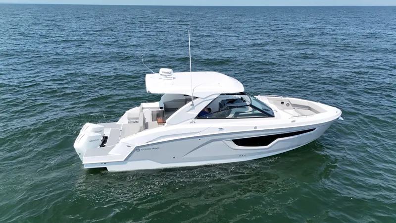 Slide: The Image of 2025 Cruisers Yachts 34 GLS Outboard on open water. - 2