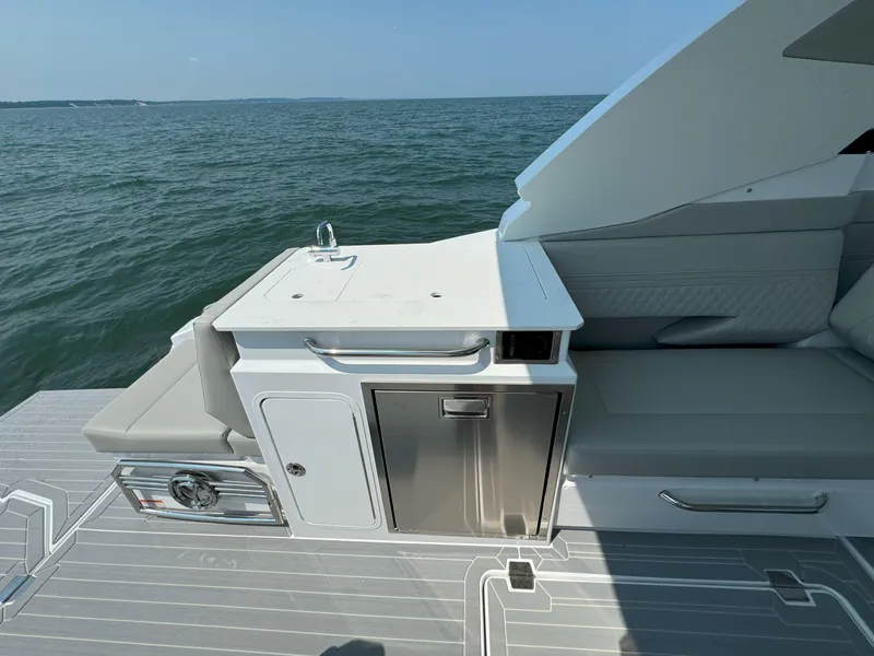 Slide: The Image of 2025 Cruisers Yachts 34 GLS Outboard, sleek deck view with seating and storage. - 21