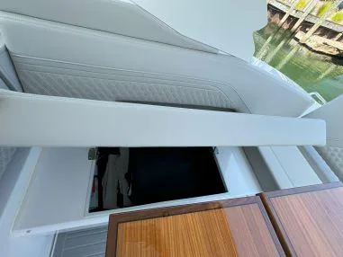 Slide: The Image of 2025 Cruisers Yachts 34 GLS Outboard interior seating and storage compartment. - 26