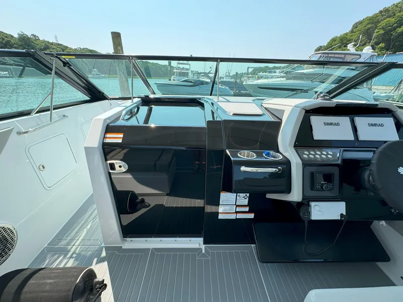 Slide: The Image of 2025 Cruisers Yachts 34 GLS Outboard cockpit with modern controls and scenic marina view. - 35