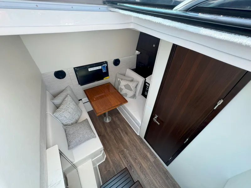 Slide: The Image of 2025 Cruisers Yachts 34 GLS Outboard cabin with modern interior and cozy seating area. - 38