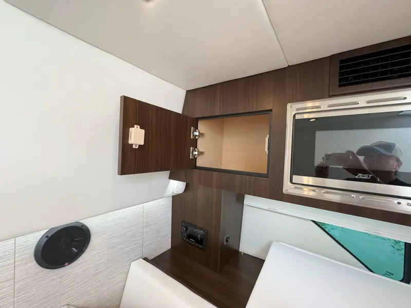 Slide: The Image of 2025 Cruisers Yachts 34 GLS Outboard interior with microwave and open cabinet. - 43