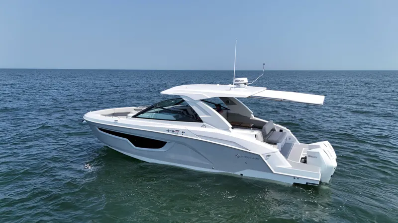 Slide: The Image of 2025 Cruisers Yachts 34 GLS Outboard on open water, sleek design, sunny day. - 6