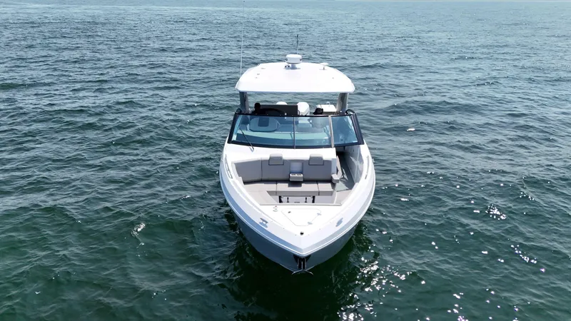 Slide: The Image of 2025 Cruisers Yachts 34 GLS Outboard on open water, front view. - 8