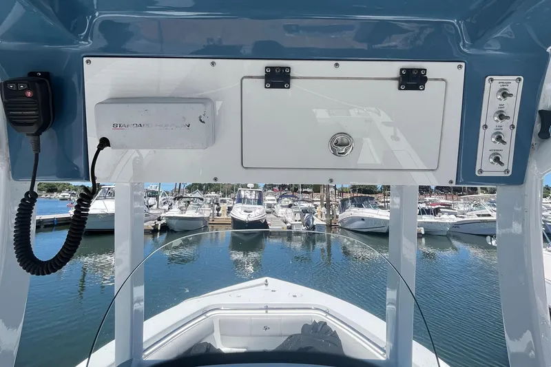 Slide: The Image of 2019 Sea Pro 239 Center Console boat dashboard with marina view. - 13