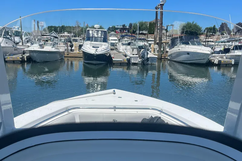 Slide: The Image of View from a 2019 Sea Pro 239 Center Console boat docked at a marina. - 14