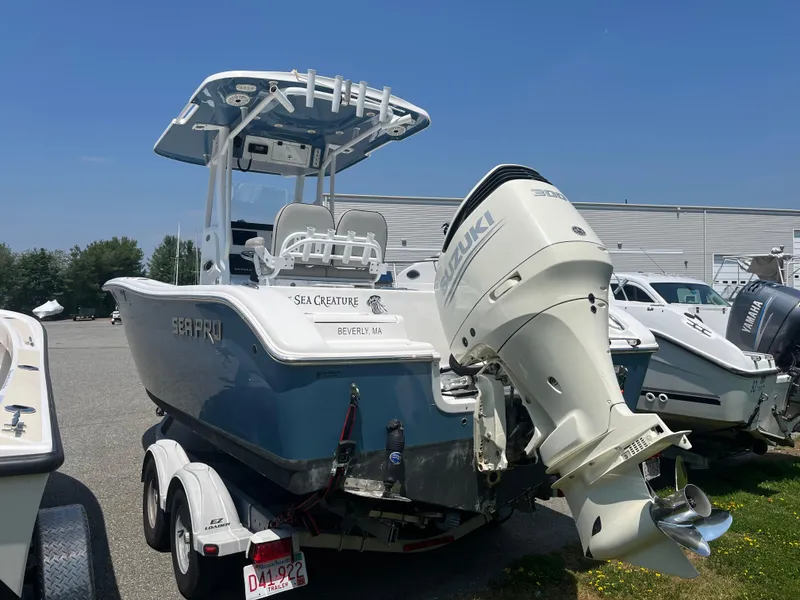 Slide: The Image of 2019 Sea Pro 239 Center Console boat with Suzuki outboard motor on trailer. - 2