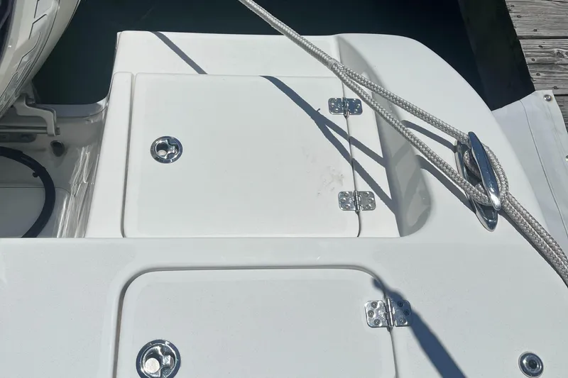 Slide: The Image of 2019 Sea Pro 239 Center Console boat deck with storage compartments and rope cleat. - 21