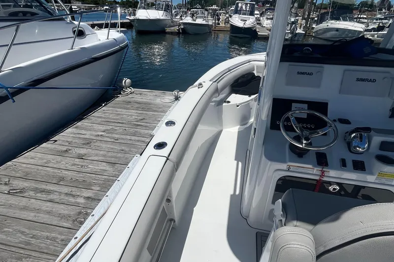 Slide: The Image of 2019 Sea Pro 239 Center Console boat docked at a marina. - 22