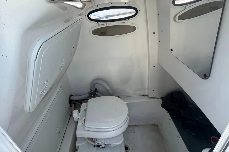 Slide: The Image of 2019 Sea Pro 239 Center Console boat interior with marine toilet and storage compartments. - 24