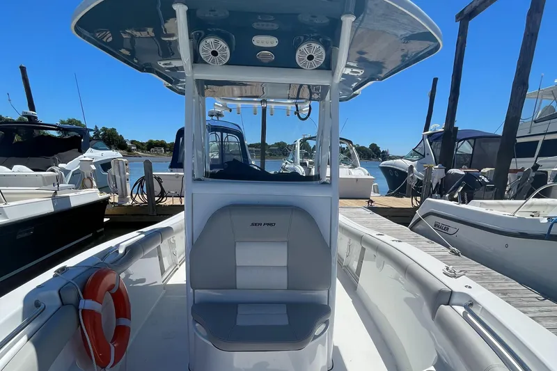 Slide: The Image of 2019 Sea Pro 239 Center Console boat docked at a marina on a sunny day. - 25