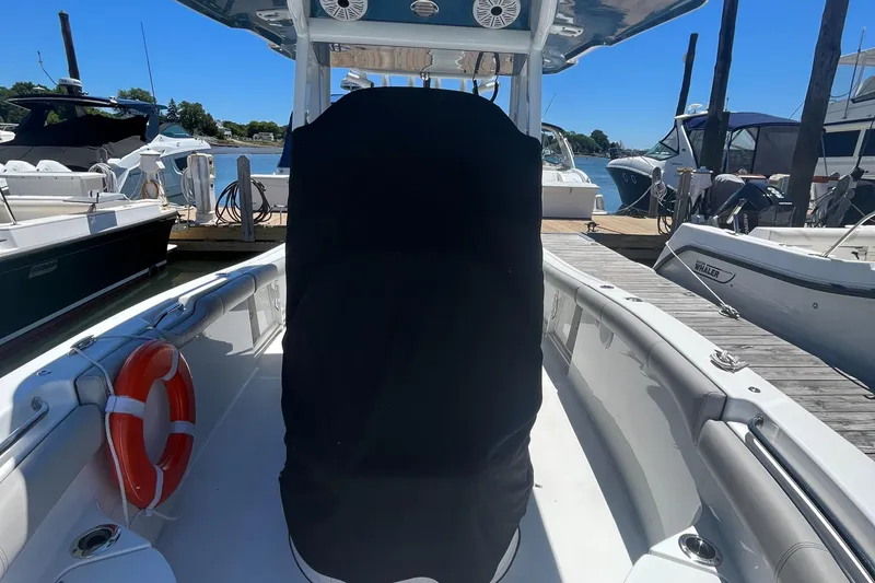 Slide: The Image of 2019 Sea Pro 239 Center Console boat docked at marina with covered console. - 28