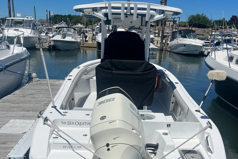 Slide: The Image of 2019 Sea Pro 239 Center Console boat docked at a marina. - 4