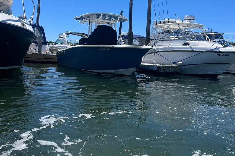 Slide: The Image of 2019 Sea Pro 239 Center Console boat docked between other boats. - 5