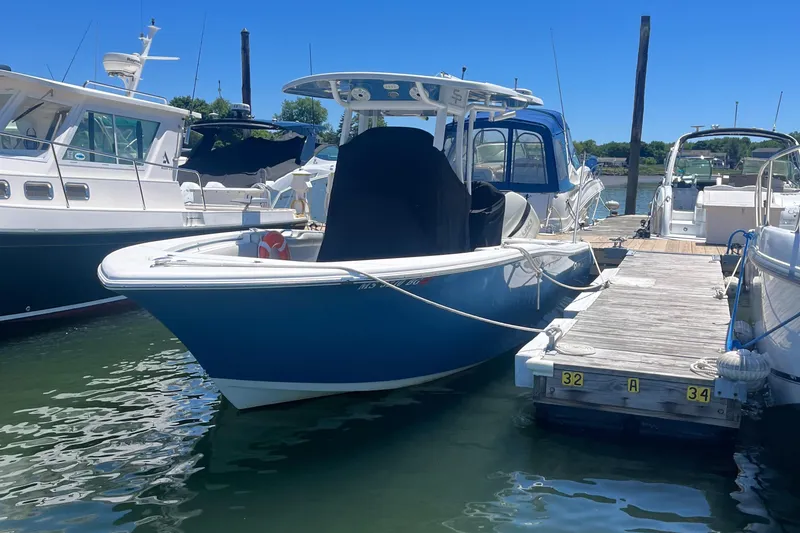 Slide: The Image of 2019 Sea Pro 239 Center Console boat docked at a marina. - 6
