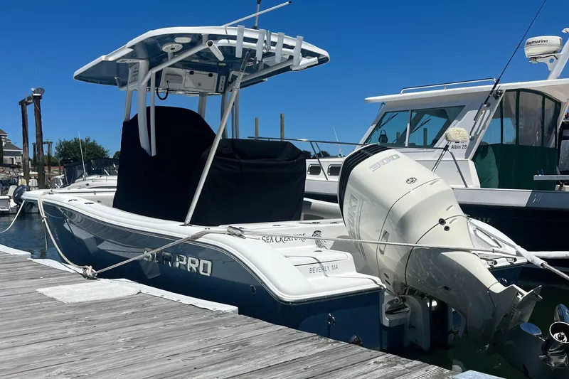 Slide: The Image of 2019 Sea Pro 239 Center Console boat docked at a marina. - 9