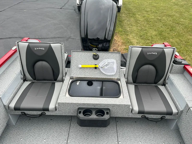 Slide: The Image of 2025 Lund 1675 Adventure SS boat interior with two seats and fishing gear. - 11