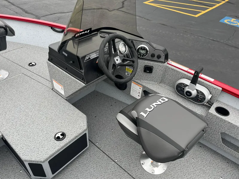 Slide: The Image of 2025 Lund 1675 Adventure SS boat interior with steering wheel and seat. - 12
