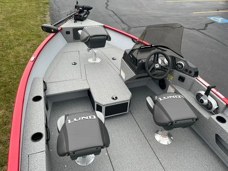 Slide: The Image of 2025 Lund 1675 Adventure SS boat interior with steering console and seating. - 5