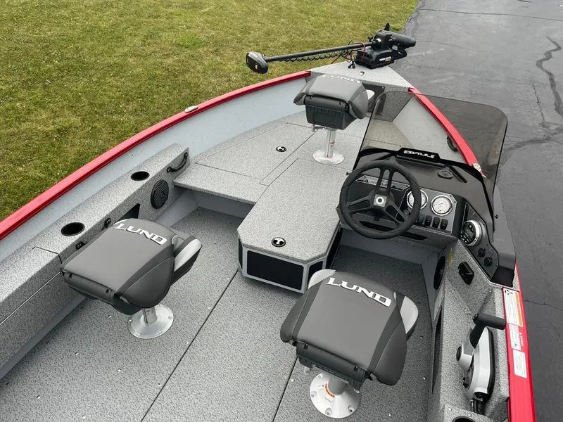 Slide: The Image of 2025 Lund 1675 Adventure SS boat interior with seating and steering console. - 6