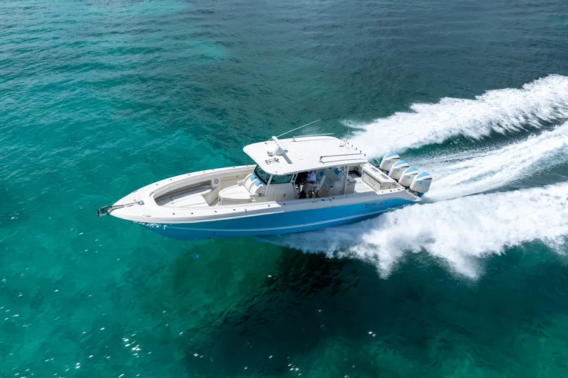 Slide: The Image of 2018 Hydra-Sports 4200 Siesta boat cruising on clear turquoise water. - 13