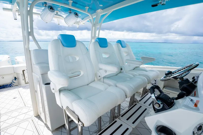 Slide: The Image of 2018 Hydra-Sports 4200 Siesta boat interior with white leather seats and blue accents. - 31