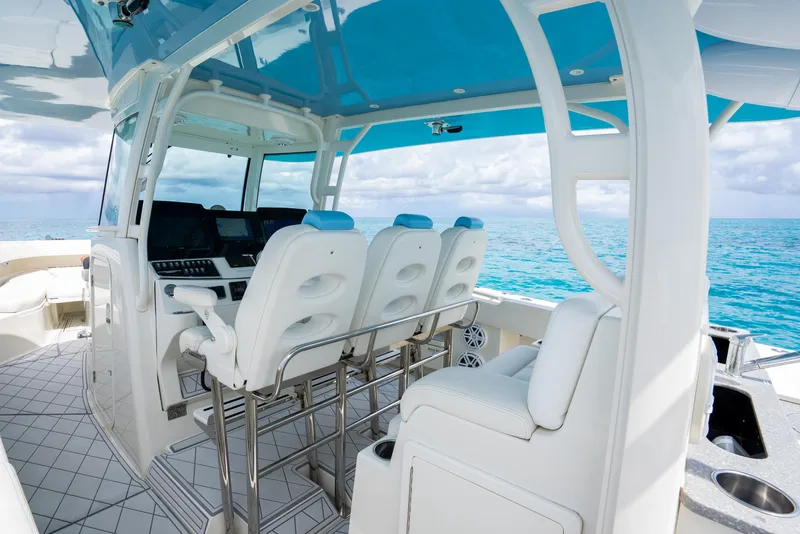 Slide: The Image of 2018 Hydra-Sports 4200 Siesta boat interior with white seating and blue accents. - 33