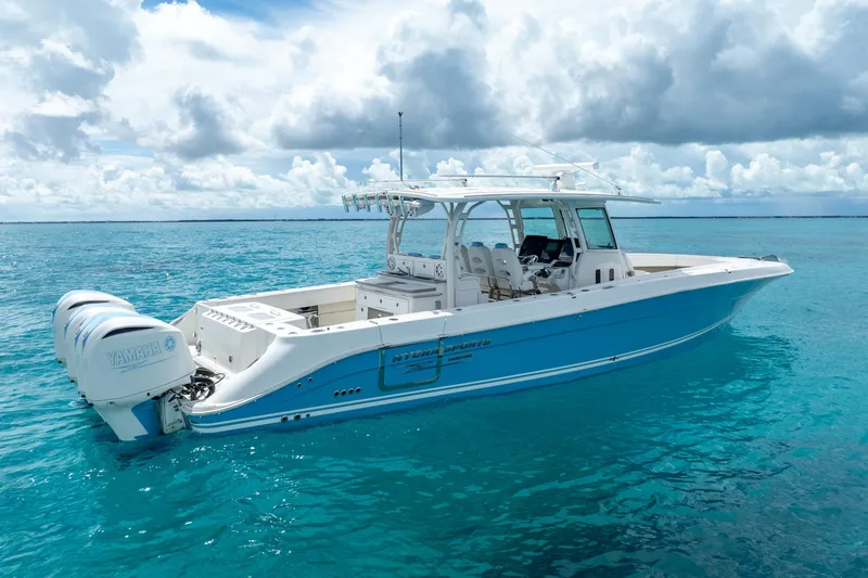 Slide: The Image of 2018 Hydra-Sports 4200 Siesta boat on clear blue water under cloudy sky. - 4