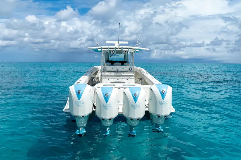 Slide: The Image of 2018 Hydra-Sports 4200 Siesta boat with four engines on clear blue water. - 8