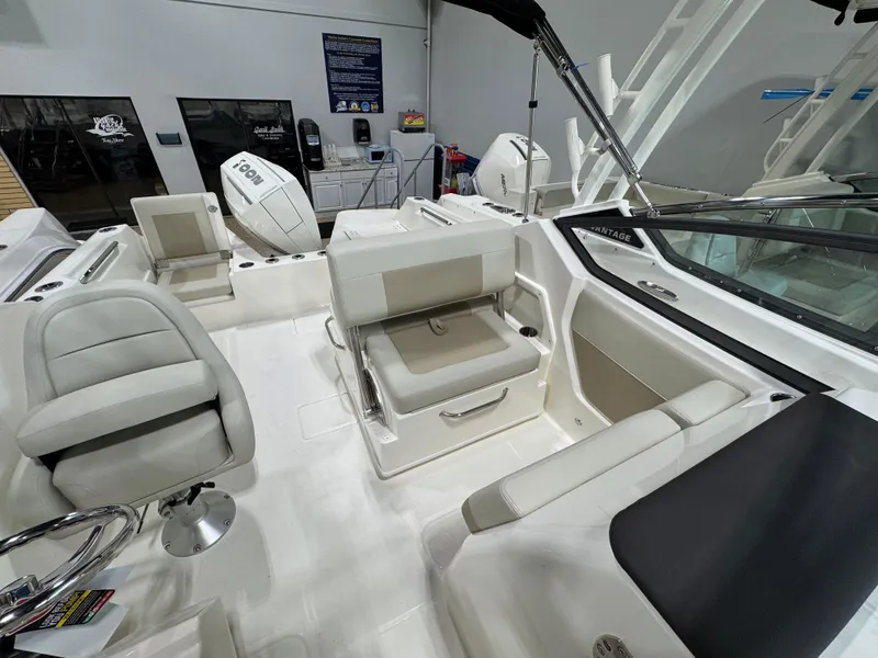 Slide: The Image of 2025 Boston Whaler 210 Vantage boat interior with seating and controls. - 10