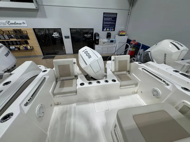 Slide: The Image of 2025 Boston Whaler 210 Vantage boat interior with seating and engine view. - 11