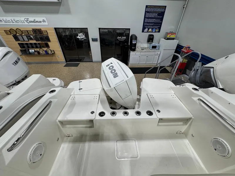 Slide: The Image of 2025 Boston Whaler 210 Vantage boat interior with Yamaha outboard motor in showroom. - 12