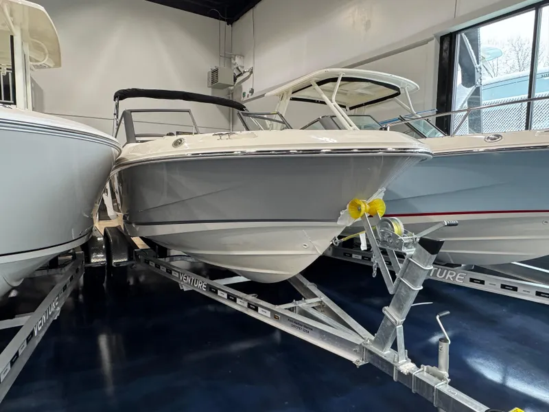 Slide: The Image of 2025 Boston Whaler 210 Vantage boat on trailer in showroom. - 3