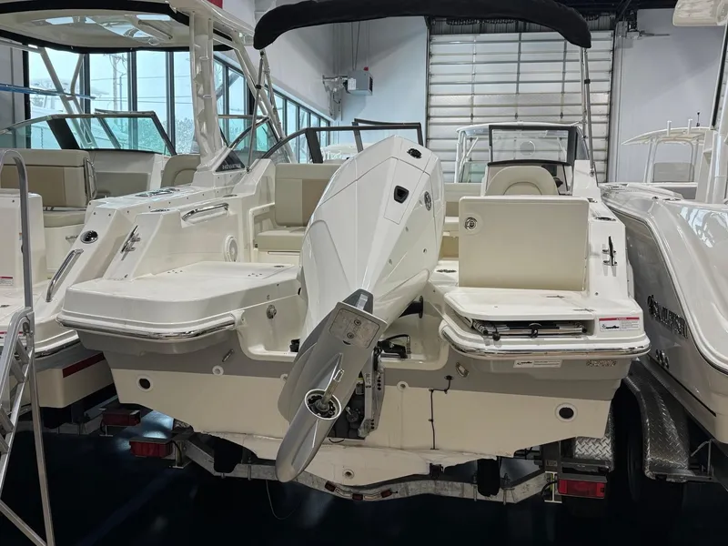 Slide: The Image of 2025 Boston Whaler 210 Vantage boat with outboard motor in showroom. - 5