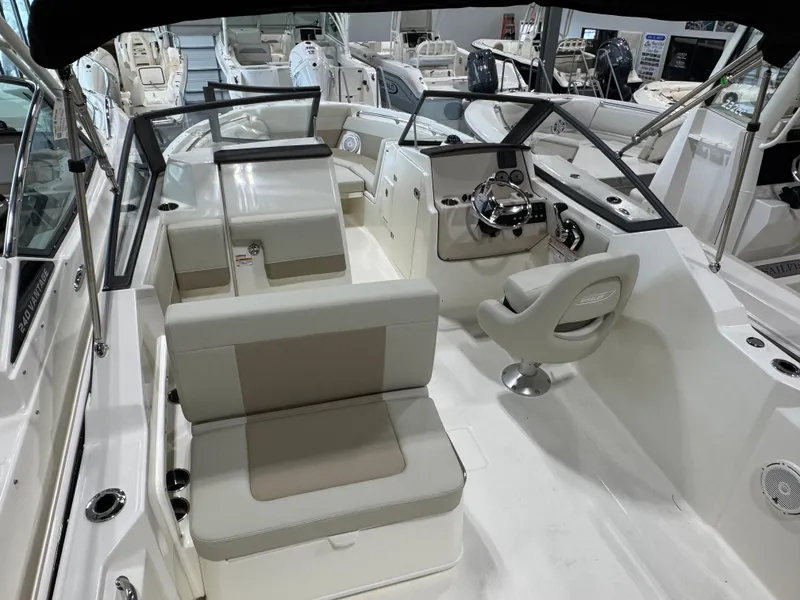 Slide: The Image of 2025 Boston Whaler 210 Vantage boat interior with seating and steering console. - 6