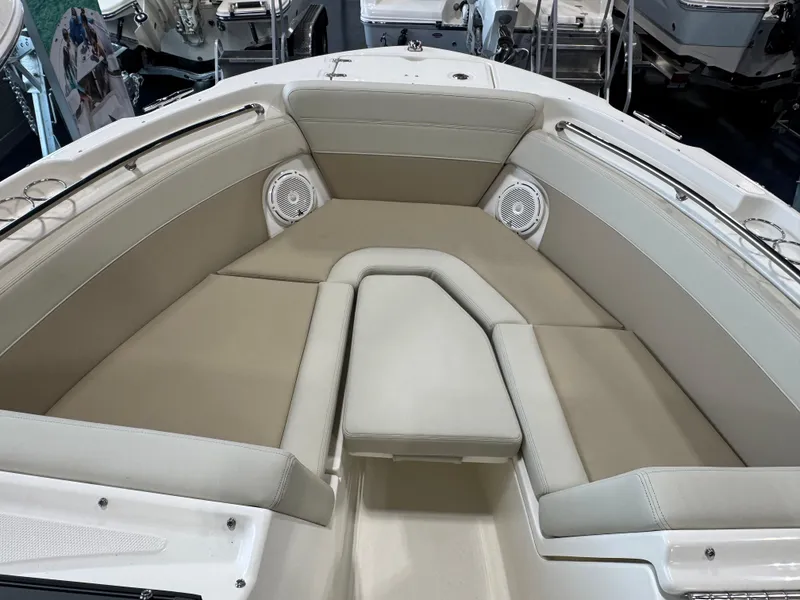Slide: The Image of 2025 Boston Whaler 210 Vantage boat interior with beige seating and built-in speakers. - 7