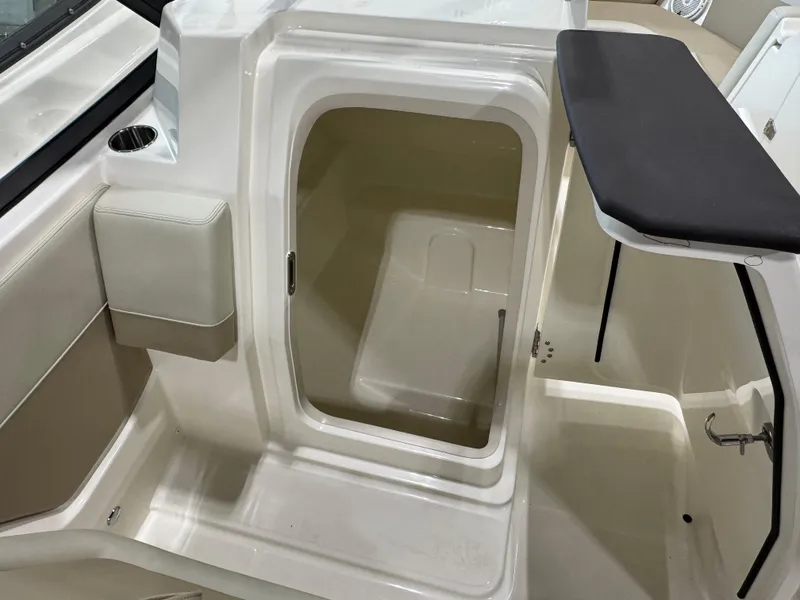Slide: The Image of 2025 Boston Whaler 210 Vantage interior cabin with open door and seating area. - 8