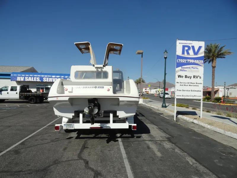 Slide: The Image of 1996 Hallett Party Cruiser Gull Wing 300 boat on trailer at RV sales lot. - 11