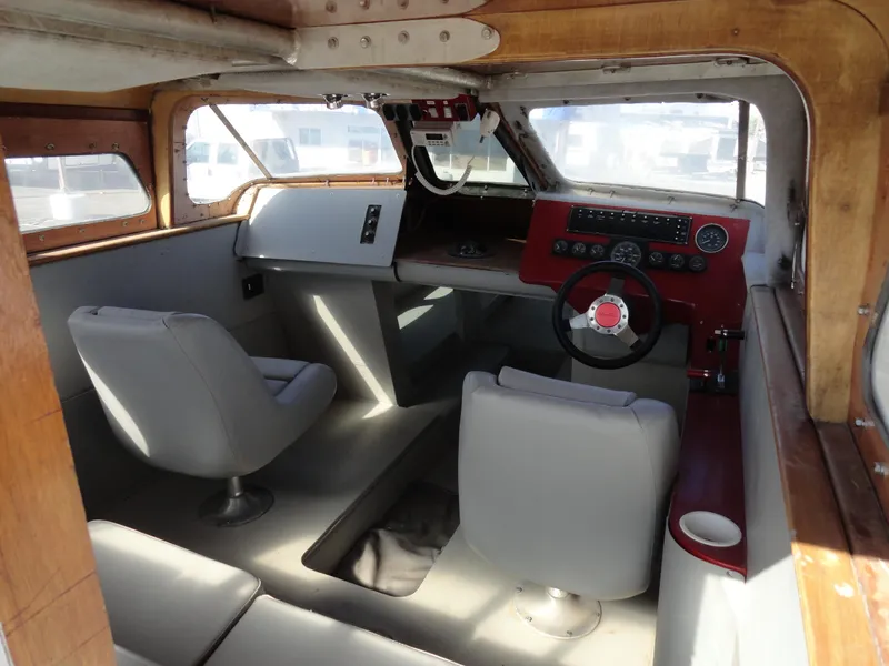 Slide: The Image of Interior of 1996 Hallett Party Cruiser Gull Wing 300 with steering wheel and seating. - 12
