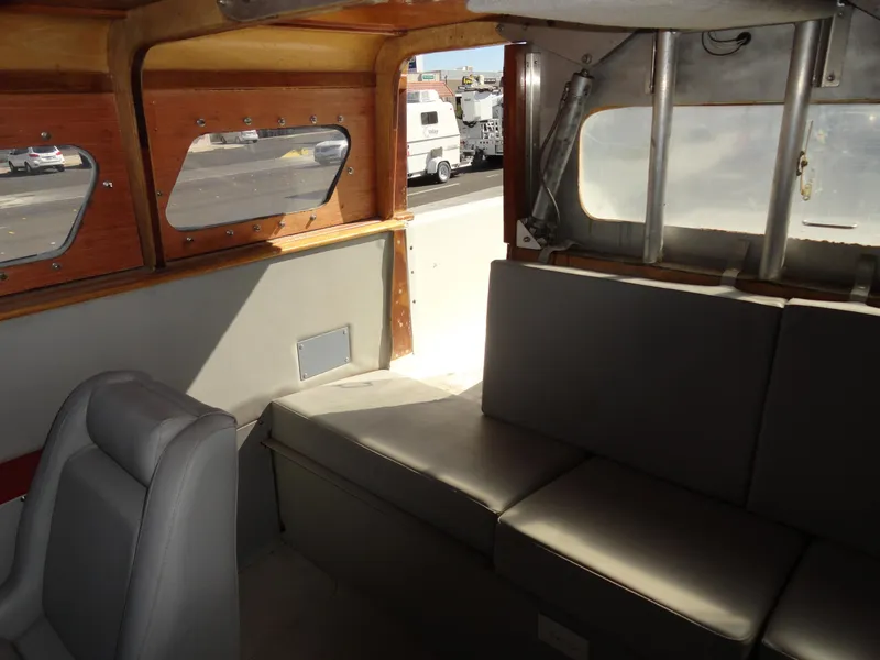 Slide: The Image of Interior of 1996 Hallett Party Cruiser Gull Wing 300 with grey seating and wooden accents. - 21