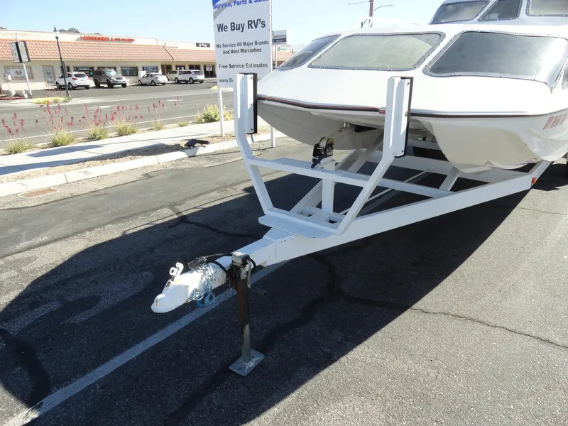 Slide: The Image of 1996 Hallett Party Cruiser Gull Wing 300 on trailer in parking lot. - 24